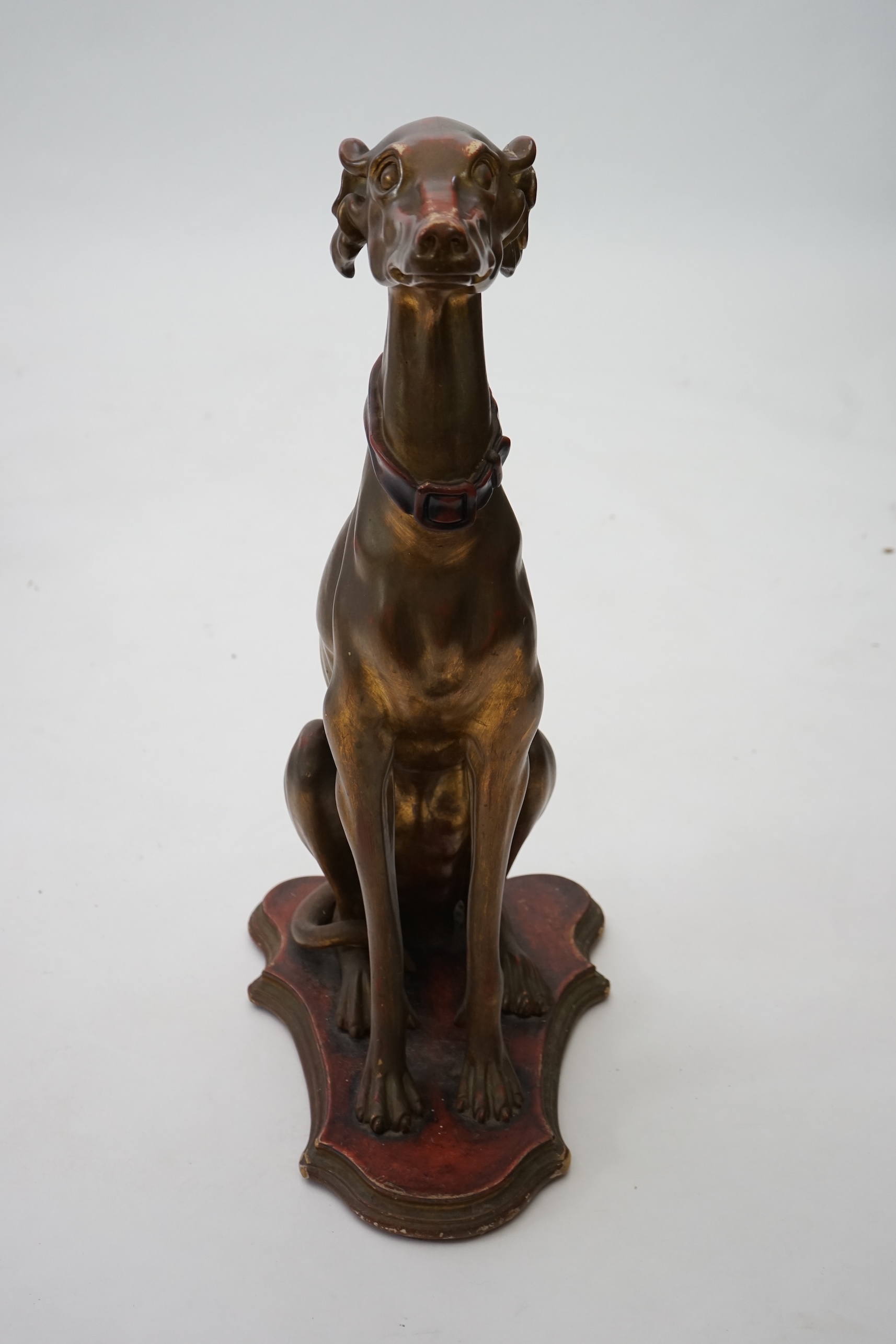 A 20th century Italian gilt and painted model of a seated Greyhound